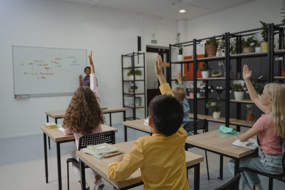 Diverse group of students raising hands in a vibrant classroom setting with teacher at front