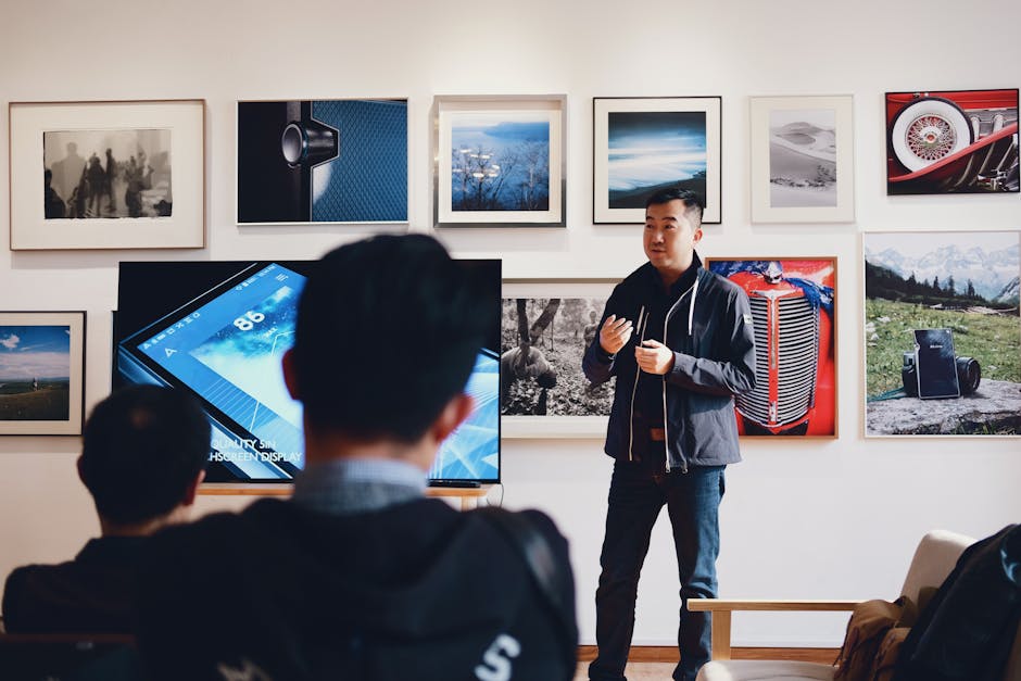 Man giving a presentation in a modern art gallery setting, engaging audience